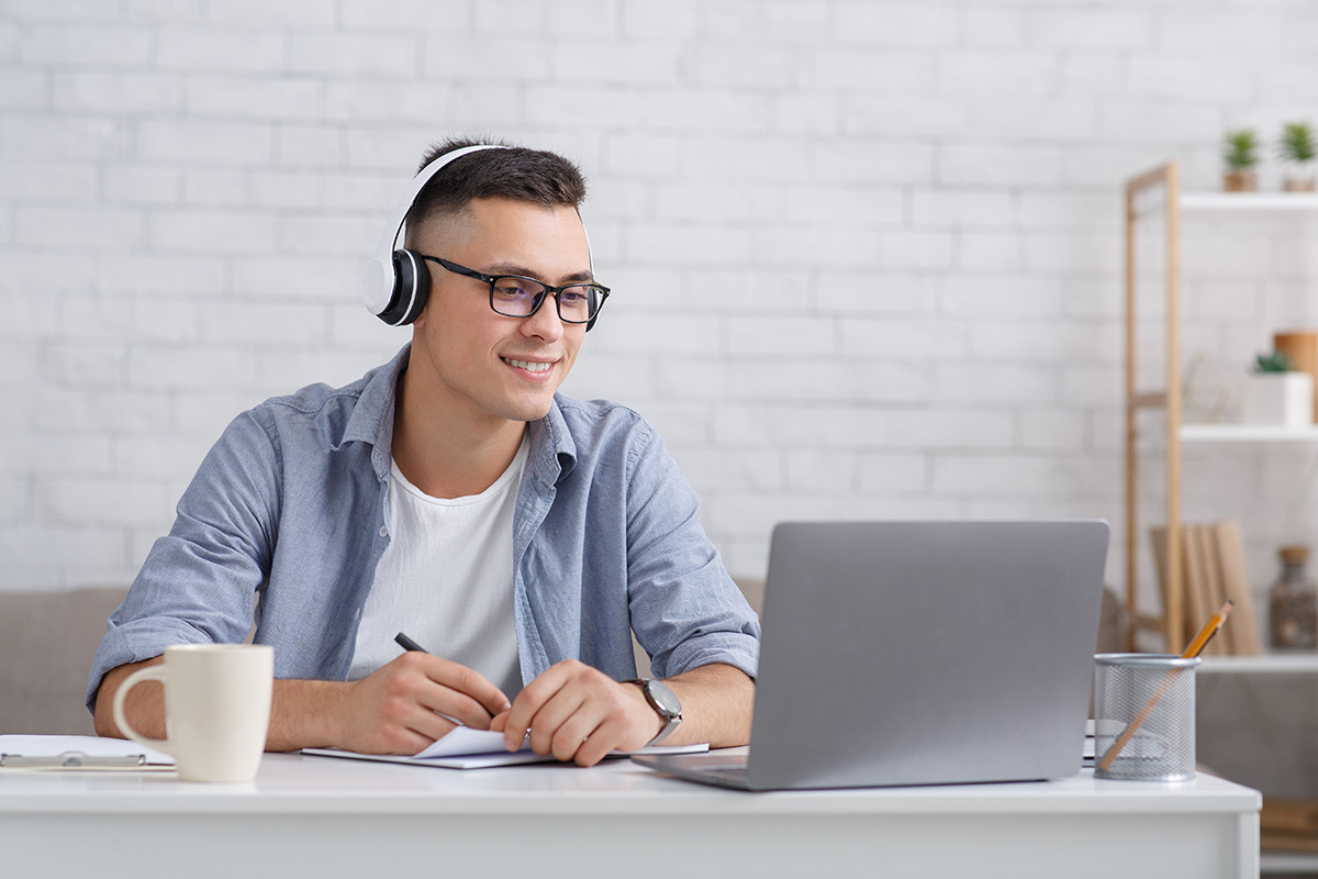 Man watching and listening to an e-learning video on a laptop - ELT and e-learning audio production