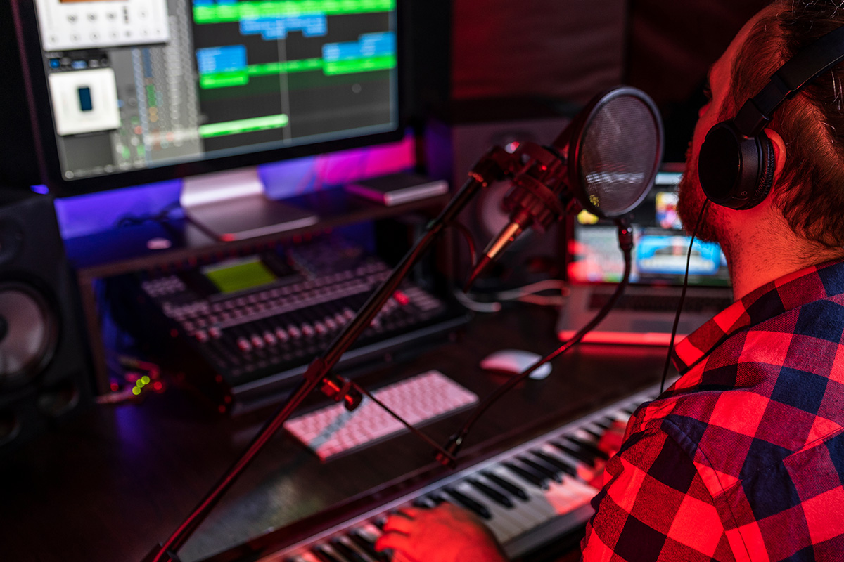 Man composing and recording a radio jingle in a recording studio - Jingle and music production