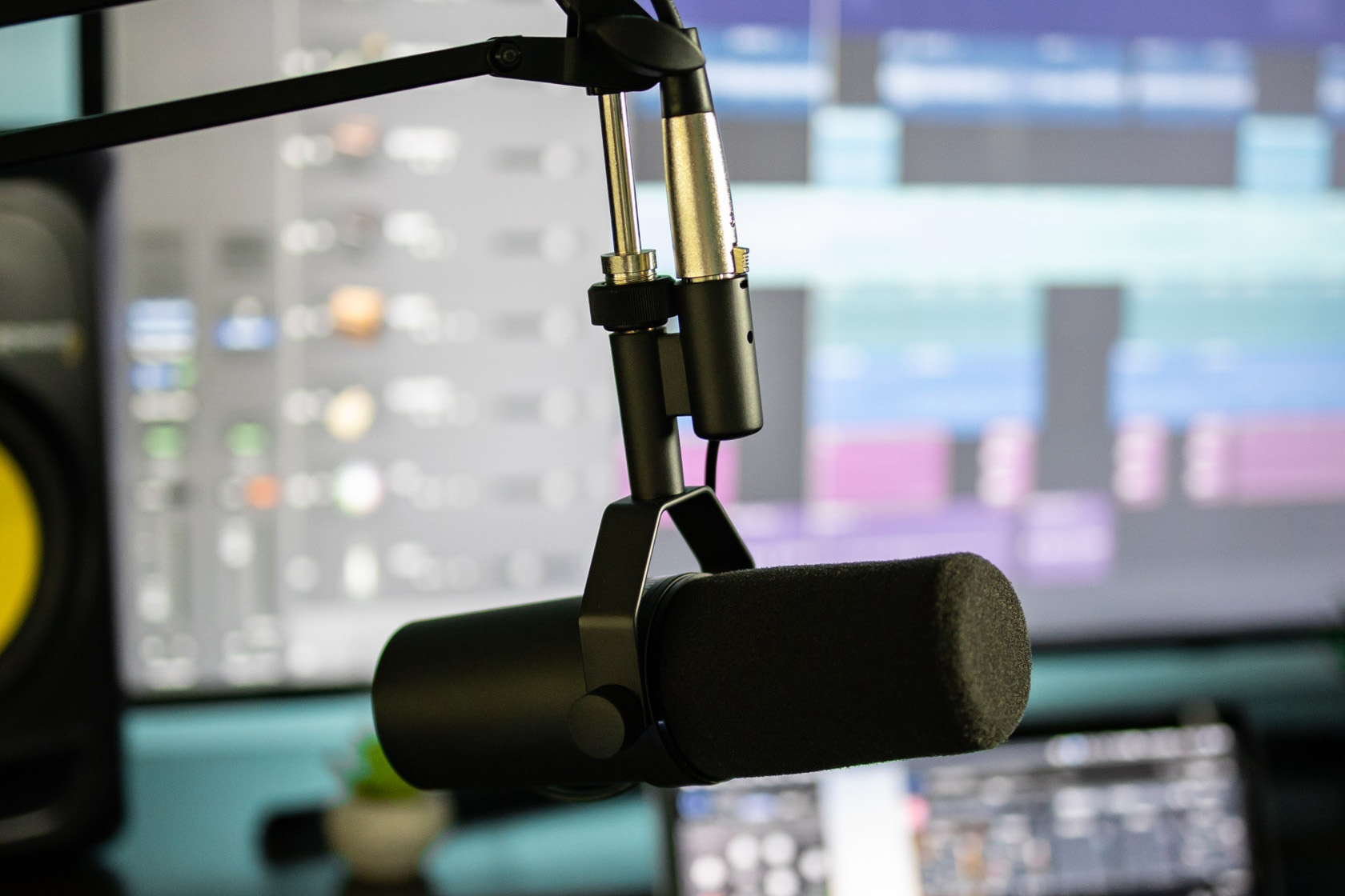 Microphone in front of computer screens producing radio commercials - Audio production